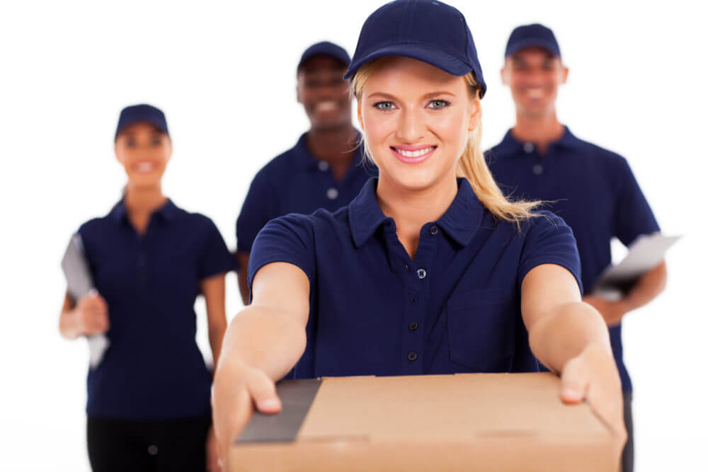 friendly delivery woman presenting parcel